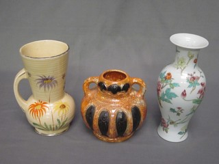 An Arthur Wood Art Deco yellow glazed jug with floral decoration 9", an Oriental vase 10", an Art Pottery twin handled vase 7"
