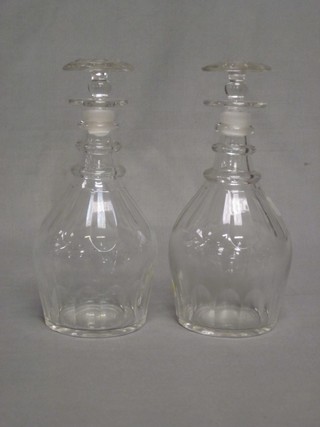 A pair of Georgian club shaped ring neck decanters and stoppers