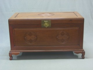 A Chinese carved Padouk wood coffer with hinged lid, raised on bracket feet 39"