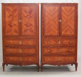A pair of 20th Century Kingwood cabinets with pink veined marble tops, the interior fitted 3 trays enclosed by panelled doors, the base fitted 3 long drawers 33"