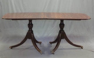 A Georgian style D end dining table, raised on a pair of 4 legged twin pillar supports