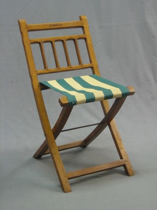 An Edwardian honey oak folding chair, marked St Helena 1901