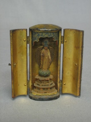 An oval Eastern lacquered shrine containing a figure of a standing Deity 3"