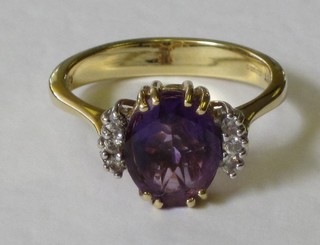 A lady's 18ct yellow gold dress ring set an oval cut amethyst surrounded by 6 diamonds