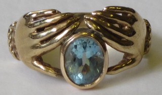 A 9ct gold friendship ring set an oval cut Topaz
