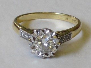 An 18ct gold dress ring set a diamond and with diamonds to the shoulders