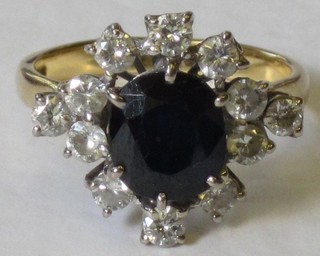 A lady's gold dress ring set an oval cut sapphire surrounded by diamonds