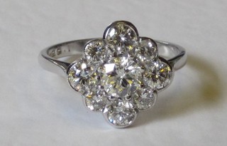 An 18ct white gold cluster dress ring set a large diamond to the centre surrounded by 8 smaller diamonds, approx 1.65ct