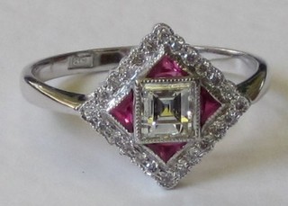 An Art Deco style 18ct white gold dress ring set a square cut diamond surrounded by rubies and diamonds, approx 0.65ct