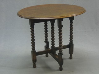 A 1930's oak oval coaching table raised on spiral turned supports 23"