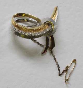 An 18ct ribbon shaped brooch set diamonds