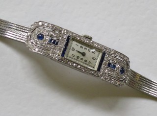 A lady's platinum cased cocktail wristwatch set sapphire and diamonds contained on a 9ct white gold strap