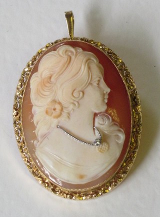 A shell carved cameo and diamond set brooch contained in an 18ct gold mount