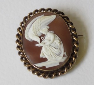 A Victorian shell carved cameo brooch of a classical lady attending an eagle, contained in a gilt metal mount