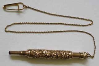 A gilt cased propelling pencil hung on a gilt chain