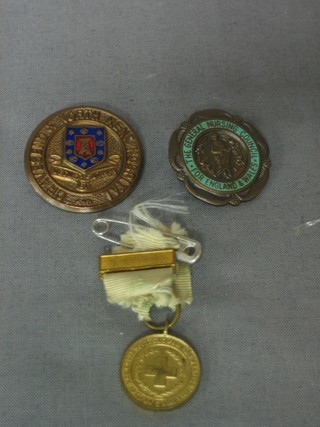 A British Red Cross WWI service miniature medal, a bronze and enamelled Graves End and North Kent nurses badge, a bronze General Nursing Council of England and Wales badge