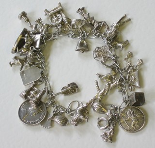 A silver curb link charm bracelet hung numerous charms