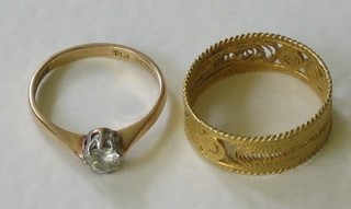 An 18ct gold dress ring set a white stone and an Eastern gilt metal ring 