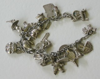 A silver curb link charm bracelet hung numerous charms
