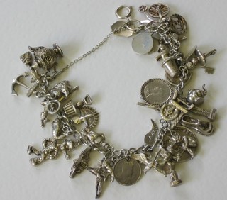 A silver curb link charm bracelet hung numerous charms