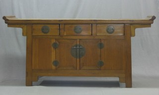 An Eastern hardwood sideboard fitted 2 drawers above a double cupboard 71"
