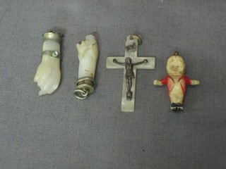 A mother of pearl crucifix, 2 carved hardstone pendants in the form of fists and a  carved bone pendant in the form of a ring master