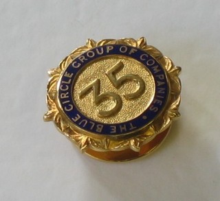 A 9ct gold and enamel Blue Circle Group of Companies 35 year service badge