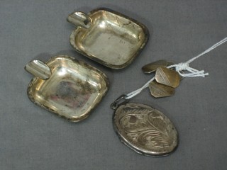 An oval engraved silver locket, a pair of silver cufflinks and a pair of silver ashtrays