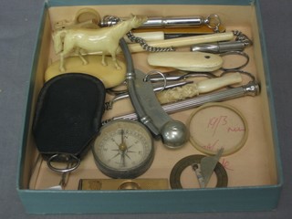 A War Office Issue Bosun's whistle, an ivory cigarette holder, a pocket sun dial and other curios