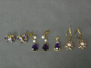 An  amethyst pendant, a pair of amethyst set earrings in the form of butterflies and 2 pairs of amethyst set earrings