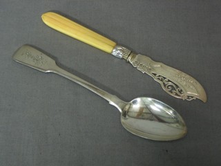 A Scots silver fiddle pattern pudding spoon Edinburgh and a Victorian silver bladed butter knife with ivory handle