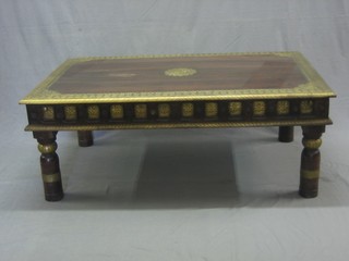 An Oriental style  rectangular hardwood coffee table with embossed brass decoration, raised on turned supports 46"