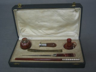 A handsome Continental polished hardstone 5 piece desk set comprising dip pen, paper knife, ink well, chamber stick and seal