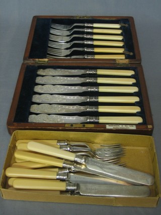 A canteen of 6 silver plated fish knives and forks contained in an oak canteen box and 6 silver plated fruit knives and forks