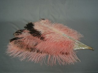 A mother of pearl and pink ostrich feather fan