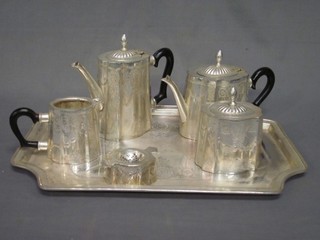 A 6 piece silver plated tea service comprising rectangular tray, teapot, coffee pot, cream jug, sucrier and tea strainer on stand