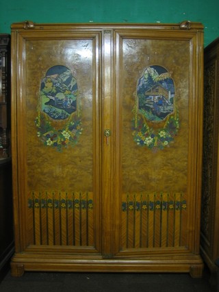 A Continental Art Nouveau figured walnut cabinet, the interior fitted shelves enclosed by panelled doors decorated Alpine scenes 16"