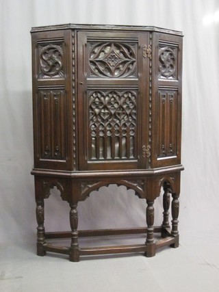A 1930's carved and pierced oak Tudor style Credence cabinet raised on turned and block supports 36"