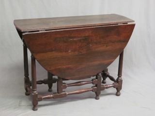 A 17th/18th Century oak gateleg drop flap dining table, fitted a frieze drawer and raised on turned supports 41"