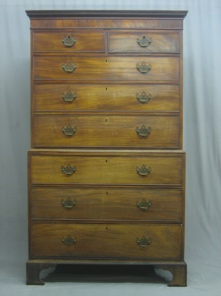 A Georgian mahogany chest on chest with moulded and dentil cornice, the upper section fitted 2 shelves above 3 long drawers, the base fitted 3 long drawers, raised on bracket feet 42"