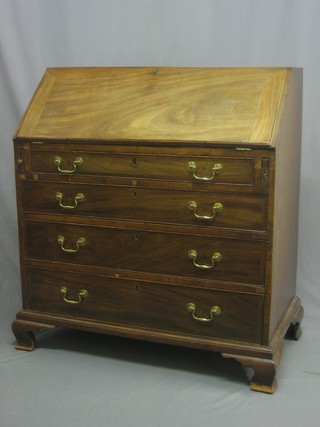 A Georgian mahogany bureau with fall front revealing a well fitted interior above 4 long graduated drawers with brass swan neck drop handles, raised on ogee bracket feet 36"