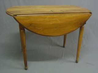 A Continental oval fruitwood drop flap dining table, raised on turned supports 43" 