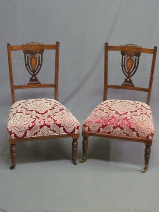 A pair of Edwardian inlaid mahogany bedroom chairs with vase shaped slat backs