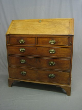 A Georgian bleached mahogany bureau with well fitted interior above 2 short and 3 long graduated drawers with oval plate drop handles, raised on bracket feet 40"
