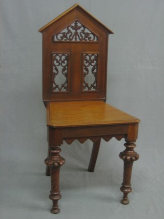 A Victorian mahogany hall chair with pierced back and solid seat