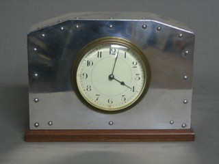 A French bedroom timepiece with  enamelled dial and Arabic numerals contained in a chrome case