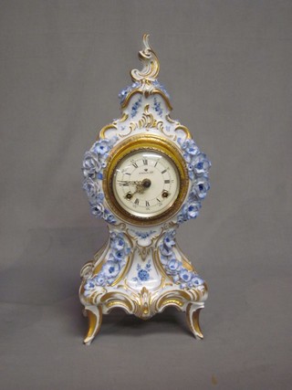 A 20th Century Continental striking mantel clock contained in a porcelain and floral encrusted case