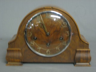 A 1930's Art Deco 8 day striking mantel clock contained in a walnut arch shaped case with Arabic numerals