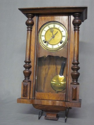 A Vienna style regulator with 5" circular dial and Roman numerals, contained in a walnut case