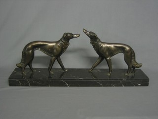 An Art Deco spelter figure of a pair of Afghan hounds, raised on a rectangular marble base 24"